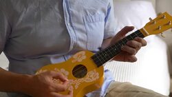 Man playing ukulele in 4K slow motion 60fps Stock Footage