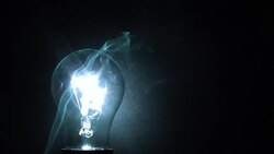 Incandescent lamp and cigarette smoke in the dark Stock Footage