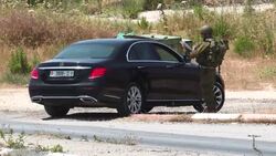 CLEAN : Israeli troops search cars at WBank checkpoint after bus stop attack News Clip