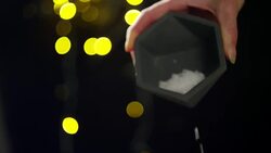 Spreading Salt with Colorful Lights on the Background Stock Footage