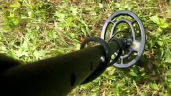 Metal Detector in Use on Grassy Meadow POV Stock Footage
