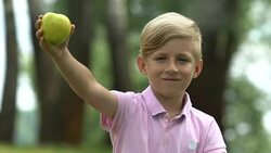 Healthy snack, happy little boy showing green apple, nutrition for school kids Stock Footage