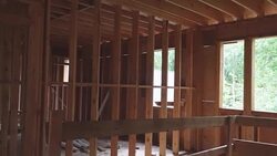 unfinished wood frame building or a house under construction Stock Footage