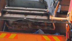 Garbage truck drives collecting garbage Stock Footage