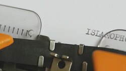 The term ISLAMOPHOBIA written on a sheet of paper coming from the right side on a typewriter Stock Footage