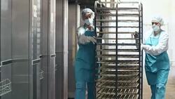 Women Pushing Baking Rack with Cookies Stock Footage