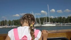 Little girl admiring the coastline of aboard a boat Stock Footage
