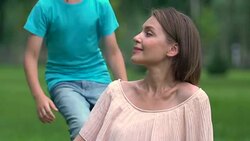 Unmarried mother looking after son in park, embracing beloved child, adoption Stock Footage