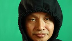 Thai man in hood  with  green background Stock Footage