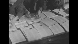 People listen to draft numbers being announced in US peacetime draft lottery News Clip