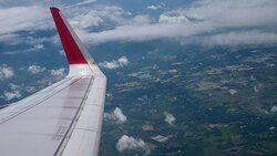 Airplane flight. Wing of an airplane flying above the clouds from window plane view Stock Footage