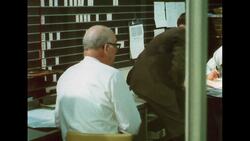 UNITED STATES 1960s: Panning shot of men in office. Stock Footage