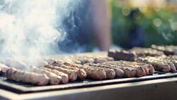 Cooking Kebabce. Balkan meatball barbeque on grill at local traditional festival Stock Footage