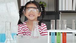 Education Topics:Funny little girl doing experiments in the laboratory.Science and education. Stock Footage