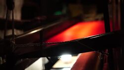 Craftsman working on huge old wooden brocade weaving looms Stock Footage