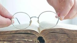 Old Glasses Placed on Vintage Book Stock Footage