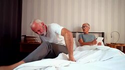 Senior man suffering from back pain getting out of bed Stock Footage