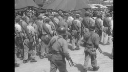 Released Chinese Communist POWs marching into internment camp in South Korea following truce between UN and North Korea ending Korean War News Clip