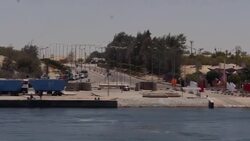Tracking shots from moving boat of ships in Suez Canal News Clip