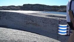 People walk among the coastal stones in Tjome nature Park, Norway Stock Footage