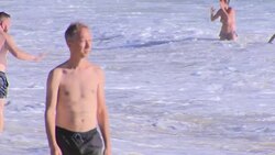 Holiday makers enjoy the sun and sea at Atlanterra Beach News Clip