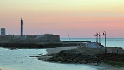Wide Angle: People on Beach of Lighthouse Tower Stock Footage