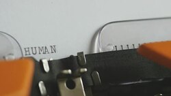 Close up footage of a person writing HUMAN RIGHTS on an old typewriter, with sound Stock Footage