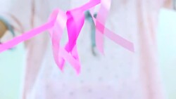 Girl with a pink ribbon. Cancer awareness concept. Stock Footage