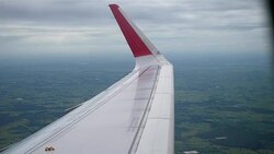 Airplane flight. Wing of an airplane flying above the clouds from window plane view Stock Footage