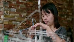 Woman hanging laundry on balcony Stock Footage