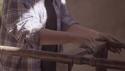 The carpenter girl works in the workshop, restored vintage furniture Stock Footage
