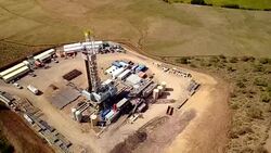 Aerial View of a Fracking Drilling Rig in the Autumn Mountains of Colorado Stock Footage