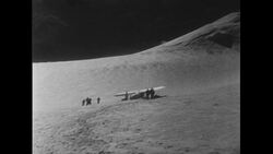 Switzerland, c.1951: A crew of men atop Mont Blanc fixed a damaged plane for nine days and prepare for takeoff Stock Footage