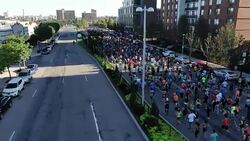 RUNNING RACE - DRONE SHOT - DRONE MOVES WITH FIELD AS THEY HEAD OUT Stock Footage