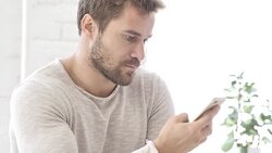 Man Using Smartphone for Online Financial Trading Stock Footage