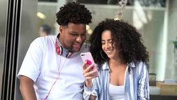 Young Couple Using Mobile at Bus Station Stock Footage