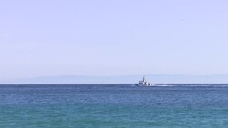 A Wide shot of a boat crashing against the waves near Atlanterra Beach News Clip