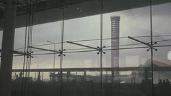 Air traffic control tower with Commuter Traveler Crowds, Tourists and Reflecting glass wall. Stock Footage