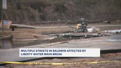 Hole in Baldwin Road after water main break sends water gushing into the streets News Clip