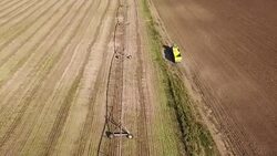Aerial view of agricultural tractor on dirt road Stock Footage