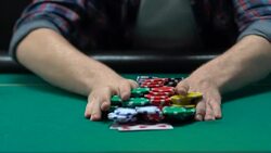 Risky man betting all chips in while playing poker in casino, gaming addiction Stock Footage