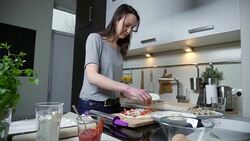 Young woman preparing pizza Stock Footage
