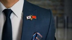 Businessman Walking Towards Camera With Friend Country Flags Pin South Korea - China Stock Footage