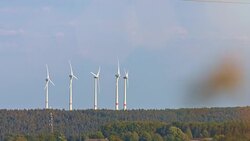 Wind turbines and agricultural fields on a summer day Stock Footage