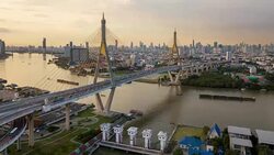 4k Hyperlapse aerial view of Bhumibol suspension bridge cross over Chao Phraya River in Bangkok city with car on the bridge at sunset sky and clouds in Bangkok Thailand. Stock Footage