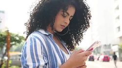 Young Girl Using Mobile Outdoors Stock Footage