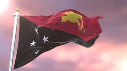 Flag of Papua New Guinea waving at wind at sunset in slow, loop Stock Footage