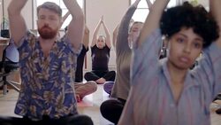 Serene creative business people practicing yoga in office Stock Footage