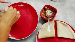 Woman folding pancakes in the kitchen Stock Footage