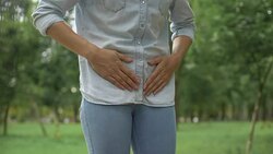 Female in jeans feeling strong lower abdominal pain, menstruation, health care Stock Footage